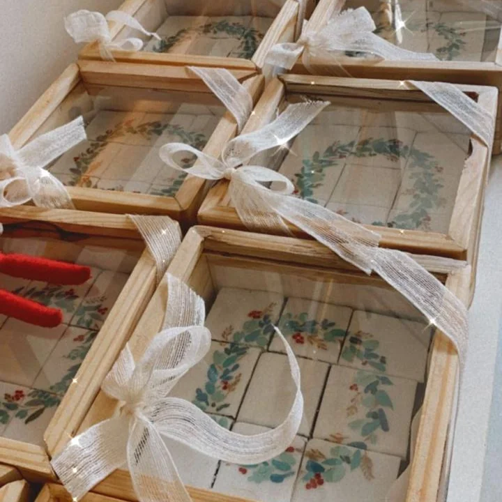 Wooden gift boxes of hand-painted shortbread truffles, tied with ribbon, ready for corporate gifting